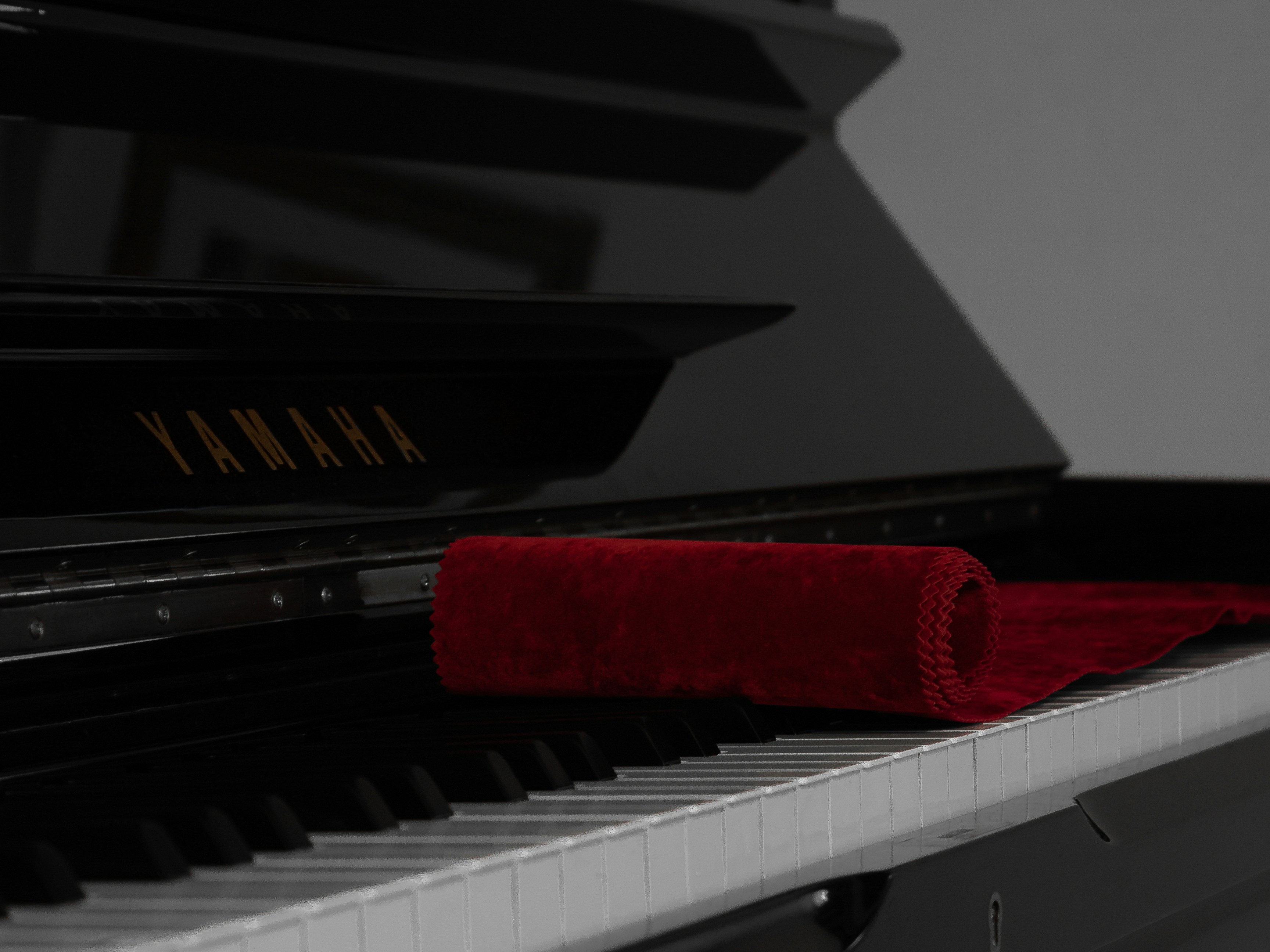Yamaha piano covered with redpiano key cover